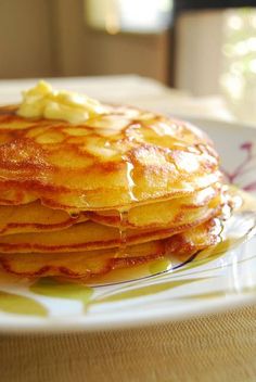 a stack of pancakes sitting on top of a white plate