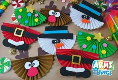 some paper fans are decorated with christmas decorations