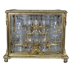 an old fashioned glass cabinet with many glasses in it