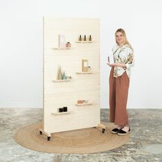 a woman standing next to a display case