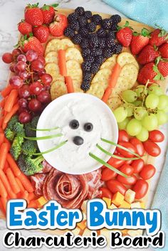 an easter bunny plate with carrots, grapes, strawberries and crackers on it