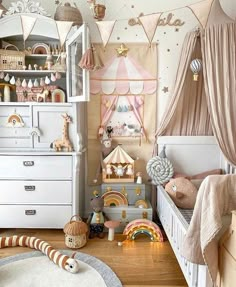 a child's bedroom decorated in pink, gold and white with lots of toys