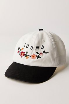 a white and black baseball cap with the word found printed on it's side