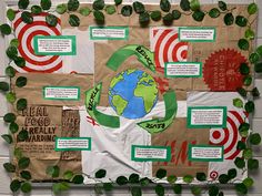 a bulletin board is covered in green leaves and paper with information about the environment on it