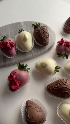 chocolate covered strawberries are arranged on a tray