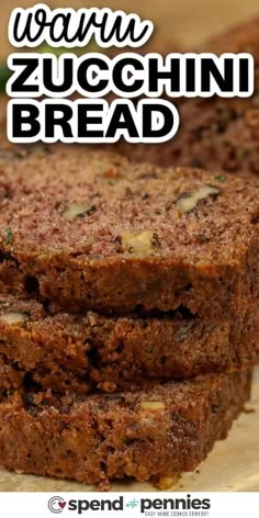 sliced zucchini bread sitting on top of a wooden cutting board with the words warm zucchini bread above it