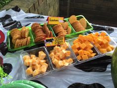 several trays of cheese and crackers on a table