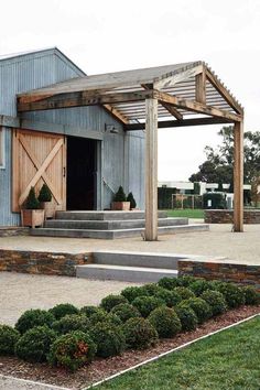 an outdoor patio with steps and planters on the side, surrounded by green grass