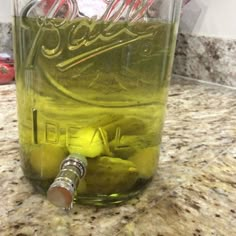 a jar filled with liquid sitting on top of a counter