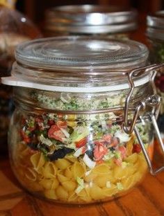 several jars filled with food sitting on top of a wooden table