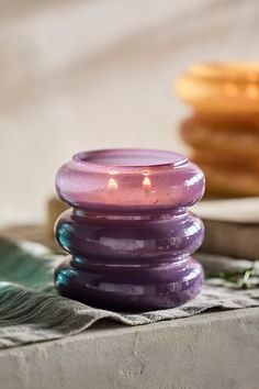 a purple candle sitting on top of a table