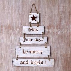 a christmas tree made out of wooden planks with the words may your days be merry and bright