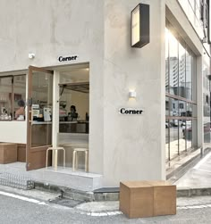 the corner of a building with people sitting at tables