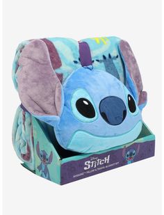 a blue stuffed animal in a box with its ears up and eyes closed, sitting on top of it's packaging