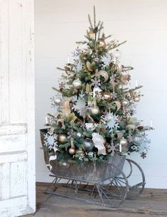 a small christmas tree sitting on top of a metal cart