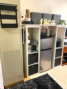 a refrigerator freezer sitting inside of a kitchen next to a wall mounted heater