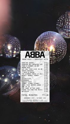 an ad for abba with disco balls in the background