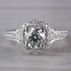 an antique style engagement ring with diamond accents