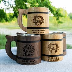 four wooden beer mugs sitting on top of a table