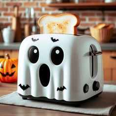 a toaster that has been decorated to look like a ghost with eyes and mouth