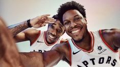 two basketball players are smiling for the camera