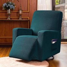 a green recliner chair sitting on top of a wooden floor