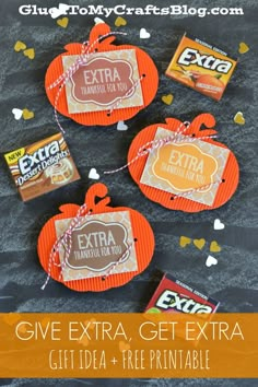 three orange pumpkin shaped candy bags tied with twine on top of a black table