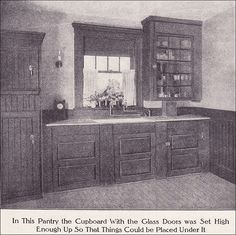 an old photo of a kitchen with wooden cabinets