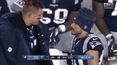 two football players are talking to each other