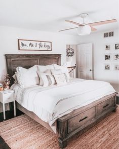 a bed with white sheets and pillows in a bedroom