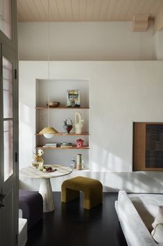 a living room filled with furniture and shelves