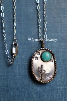 "This is a beautiful sterling silver pendant that features a beautiful desert landscape of a cactus, terrain, stars, and an 8mm Kingman Turquoise stone as the moon. It has a beautiful rope border around the pendant. This pendant hangs on a dainty sterling silver cable necklace. The pendant is 1 3/8\" tall (including bail) x 13/16\" wide. Your choice length of cable chain! Each pendant is handmade when ordered. Therefore, no two pendants will be exactly alike! The pendant you receive will look slightly different than the one pictured here, making each pendant unique!" Untreated Western Style Jewelry For Gifts, Western Style Silver Turquoise Necklace As Gift, Green Western Style Jewelry For Gift, Southwestern Sterling Silver Turquoise Cabochon Necklace, Western Style Pendant Jewelry For Gift, Western Fashion Jewelry, Vintage Turquoise Jewelry, Handmade Turquoise Jewelry, Cactus Jewelry