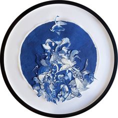 a blue and white plate with an image of birds in flight on the bottom half