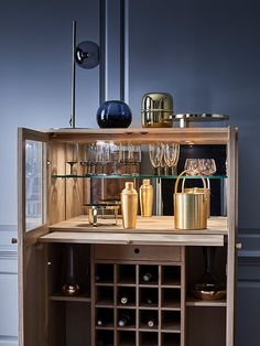 a wine cabinet with many bottles and glasses