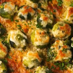 a close up view of some food with cheese and broccoli on it's surface