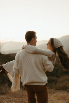 a man carrying a woman on his back