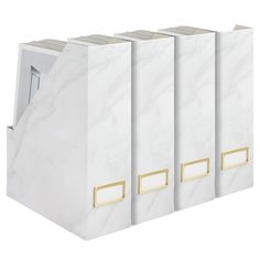 three white binders with gold handles on each side