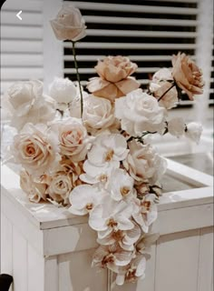 a bunch of flowers sitting on top of a counter