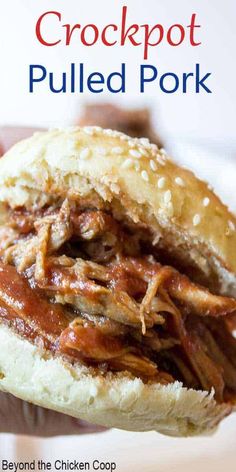 the crockpot pulled pork sandwich is in someone's hand