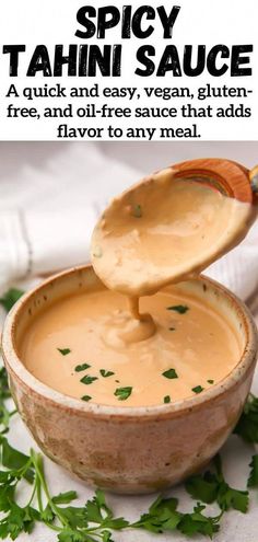 a spoon full of tahini sauce in a bowl