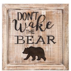 a wooden sign that says don't wake the bear with a black bear on it