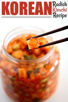 a spoon with some food in it on top of a glass jar and chopsticks