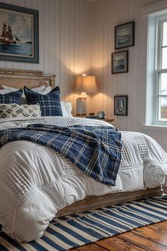 a bed with blue and white comforter in a bedroom