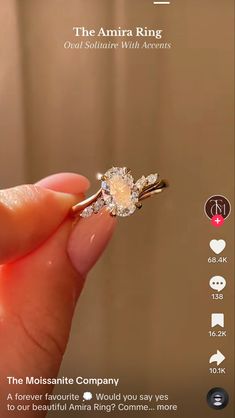 someone is holding an engagement ring in their hand with the words, the amria ring