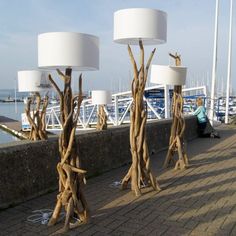 three lamps are sitting on the side of a pier