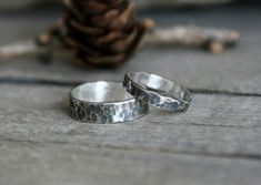 These beautiful organic bands are made of sterling silver which has been hammered and given a dark antique or a satin silver finish. Very comfortable to wear with a unique handmade rustic look, ideal as an every day ring or as wedding or couple rings.  You can choose the 3mm, 5mm or 8mm width for your ring or the bands set you prefer. If you prefer a different finish for your ring(s), please let me know in a message. All our jewelry is made in our studio by hand and we use only traditional silve Rustic Hand Forged Promise Ring, Rustic Hand Forged Silver Rings, Rustic Hand Forged Wedding Rings, Rustic Sterling Silver Jewelry For Anniversary, Rustic Silver Promise Ring, Rustic Sterling Silver Rings For Anniversary, Rustic Silver Wedding Rings, Silver Hammered Stackable Wedding Rings, Rustic Hand Forged Rings For Anniversary