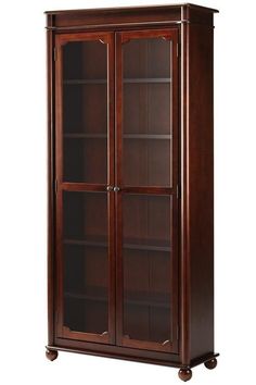 a tall wooden bookcase with glass doors on the front and bottom shelves in dark wood