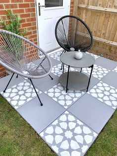 two chairs sitting on top of a cement patio