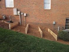 several wooden planters in front of a brick building