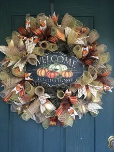 a welcome to our home wreath hanging on a door